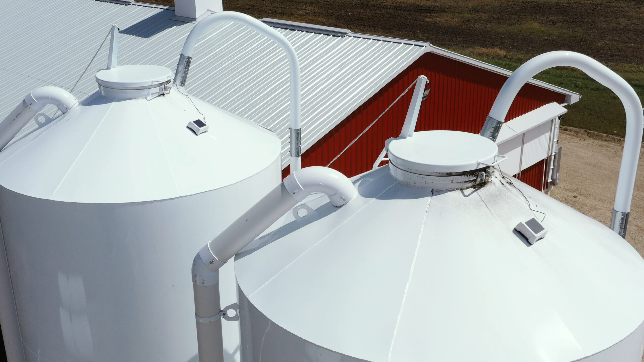 BinSentry sensors mounted to the tops of animal feed bins.