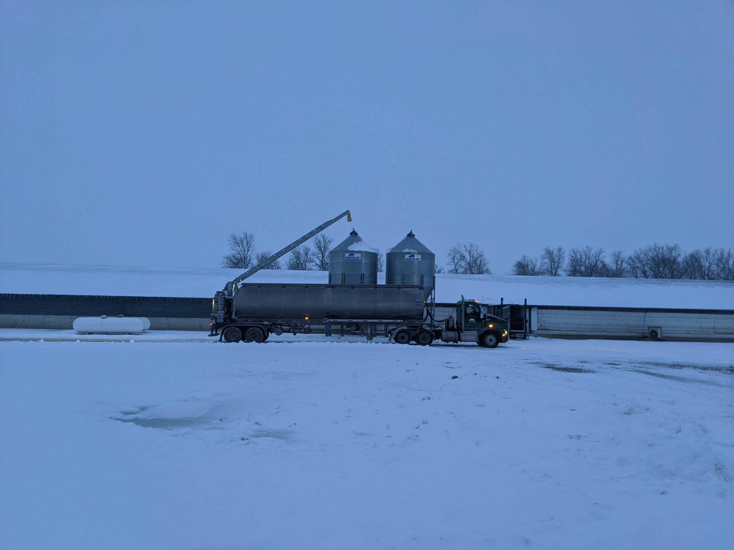 Snow covered barn and feed bins